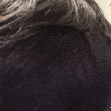 a close up of a person 's head with a few drops of water coming out of it