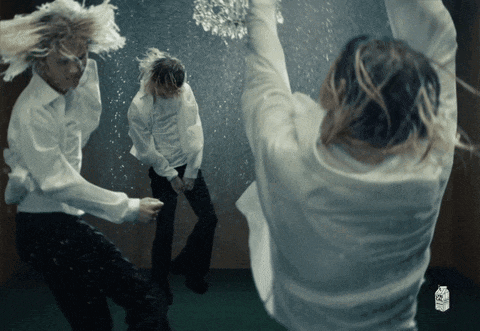a woman in a white shirt is dancing in front of a milk bottle