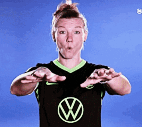 a woman in a black shirt with a green vw logo on it