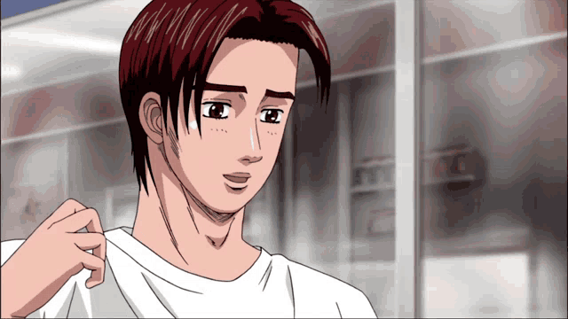 a man with red hair is wearing a white shirt and looking at something