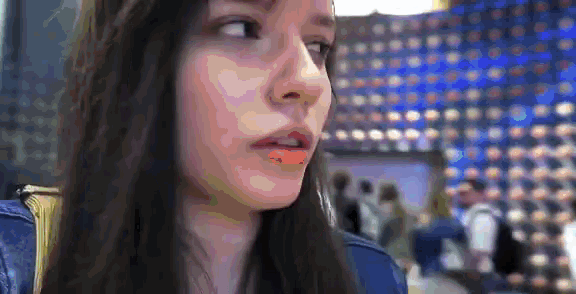 a close up of a woman 's face with a blue background .