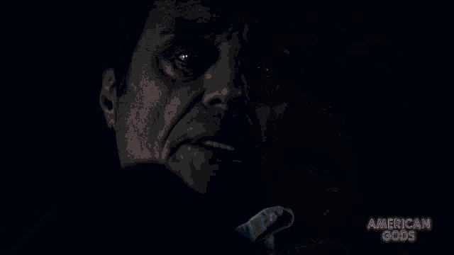 a close up of a man 's face with the words american gods written on the bottom