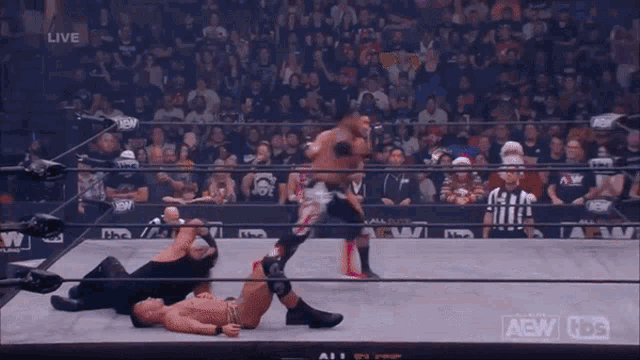two men are wrestling in a ring with aaw dynamite written on the ropes