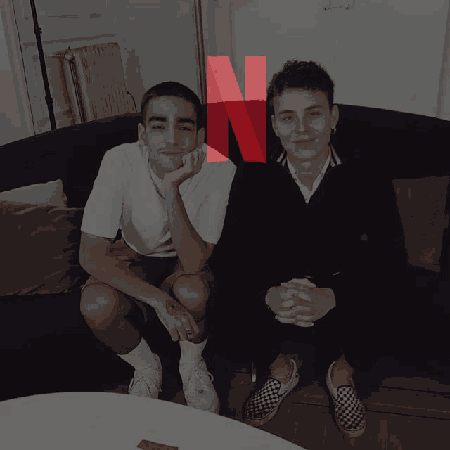 two young men sitting on a couch with a netflix logo in the corner