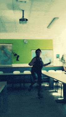 a woman is running in a room with a map on the wall that says italy