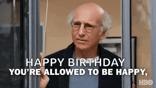 a bald man with glasses is holding a piece of paper and says `` happy birthday you 're allowed to be happy , ''
