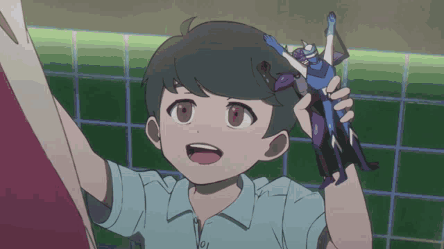 a young boy is holding a toy in his hand