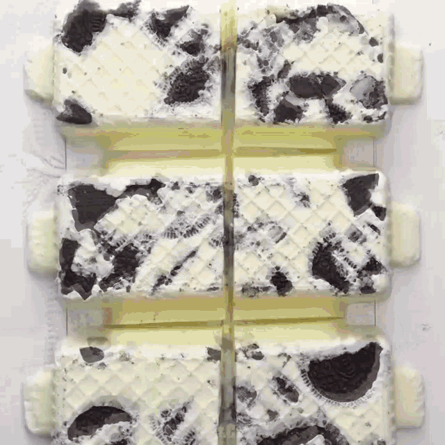 a close up of a bar of ice cream with oreos on top