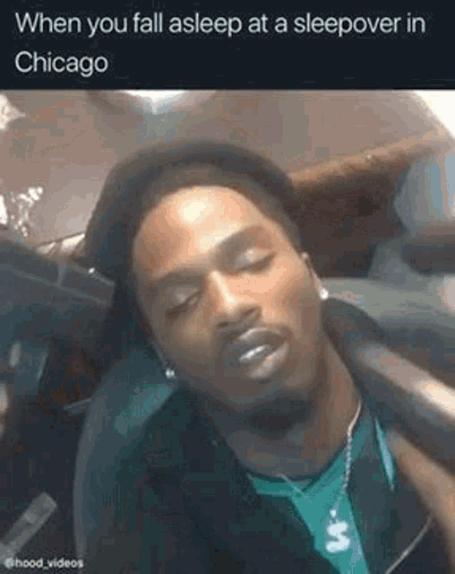 a man is sleeping in a car while wearing a hat .