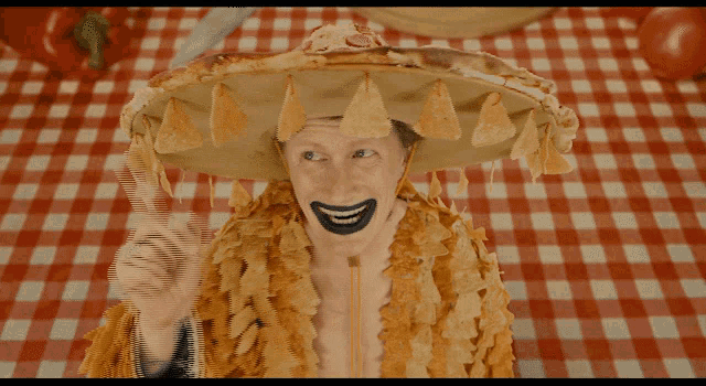 a man wearing a sombrero made out of nachos