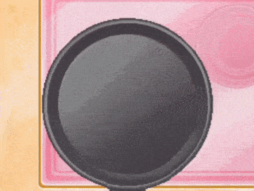 a frying pan is sitting on a pink tray