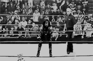 a black and white photo of a wrestler in a boxing ring