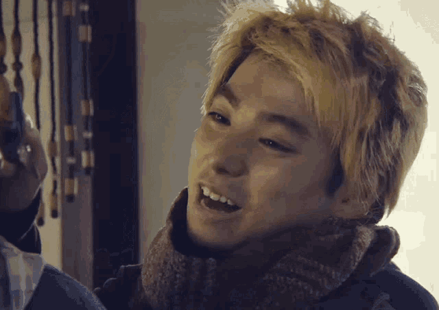 a close up of a person 's face with blonde hair