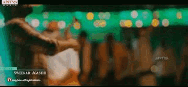 a blurry picture of a man and woman dancing in a club