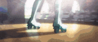 a person rollerblading on a wooden floor