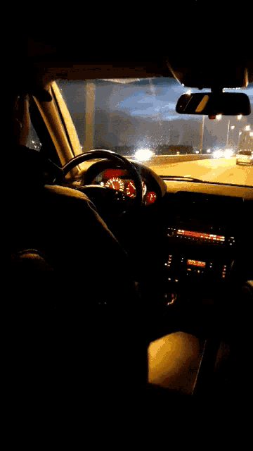 a man is driving a car with a speedometer that reads almost 200 mph
