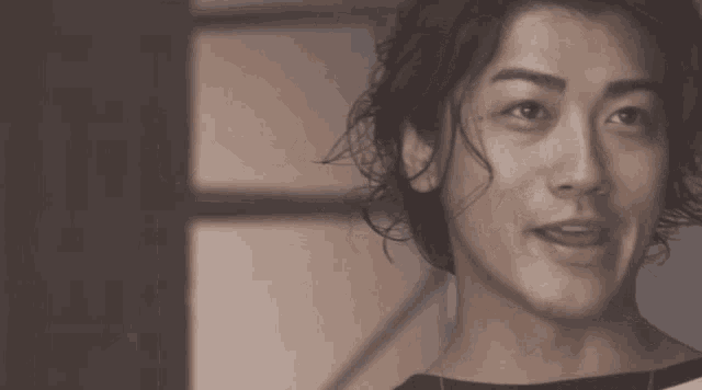 a close up of a man 's face with a slight smile on his face