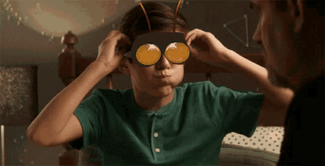 a boy wearing a mask that looks like an insect