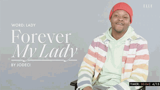 a man is sitting in a chair with his arms outstretched in front of a poster that says " forever my lady "