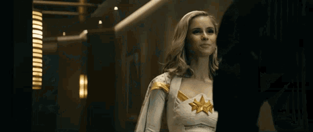 a woman in a white and gold costume is standing next to a man .