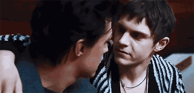 a man and a woman are looking at each other with their eyes closed