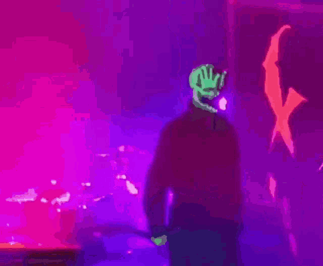 a man in a skull mask is standing on a stage