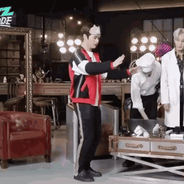 a man in a red jacket and black pants is standing in a room with a sign that says z mode