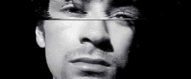 a close up of a man 's face with a black background