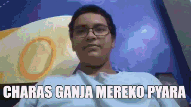 a man wearing glasses and a white shirt with the words chara 's ganja mereko pyara above him