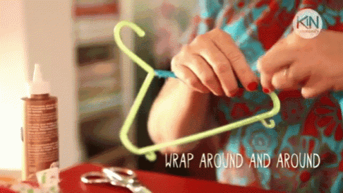 a woman is wrapping a clothes hanger around a bottle of glue