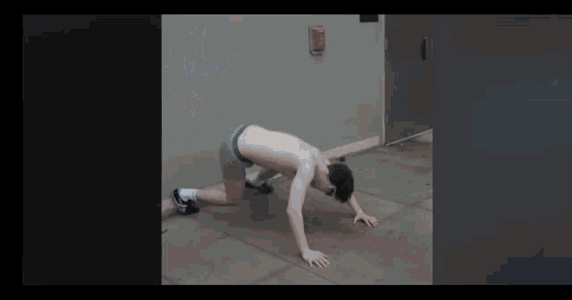 a man without a shirt is doing push ups on the ground