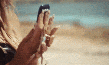 a woman is holding a car key in her hand