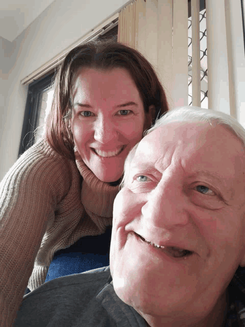 a man and a woman are smiling for a picture
