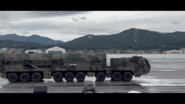 a large military vehicle is parked in a parking lot