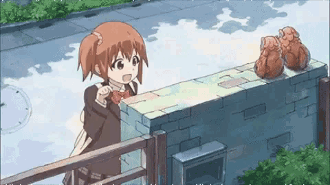 a girl in a school uniform is standing next to a brick wall ..