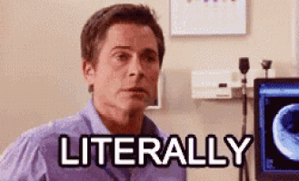 a man in a purple shirt is sitting in front of a computer with the word literally written on it .