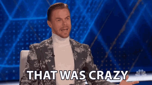 a man in a suit says that was crazy in front of a blue background