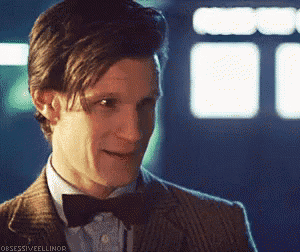 a close up of a man wearing a bow tie and a suit .