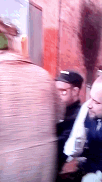 a blurry picture of a man wearing a hat that says ' ny ' on it