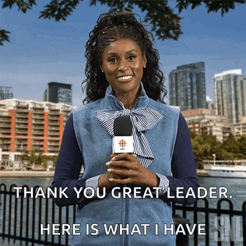 a woman holding a microphone with the words " thank you great leader here is what i have "