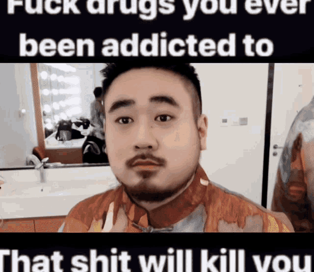 a man with a beard is standing in front of a bathroom mirror with the words " fuck drugs you ever been addicted to "