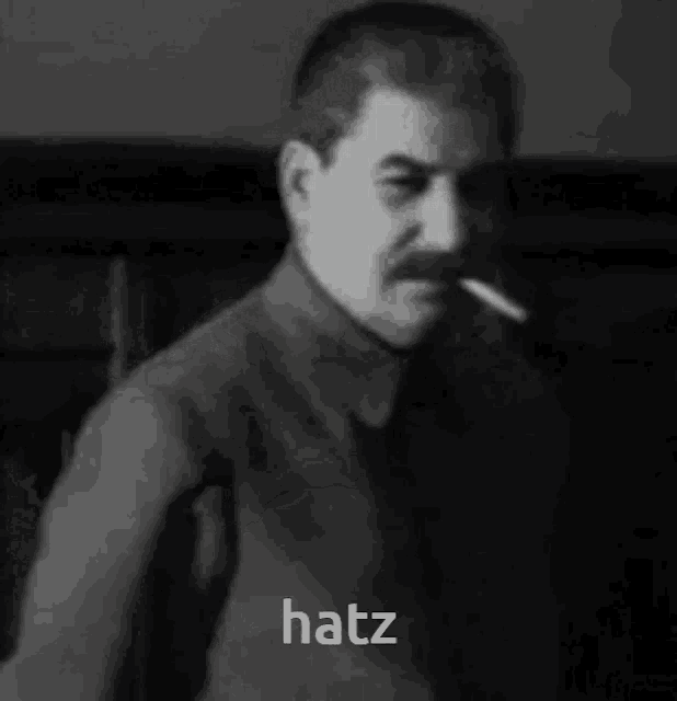 a black and white photo of a man smoking a cigarette and says hatz .