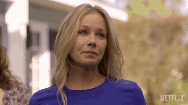 a woman in a blue shirt with the word netflix on the bottom