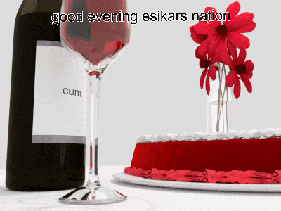 a bottle of cum wine sits next to a glass of wine and a cake