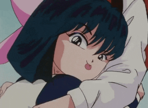 a girl with blue hair is being held by a man in a white shirt .