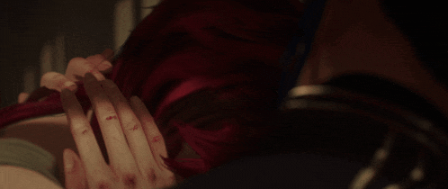 a close up of a woman with red hair looking at something
