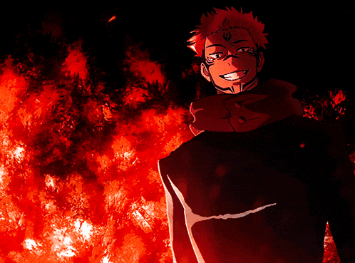 a man with a tattoo on his face is smiling in front of flames