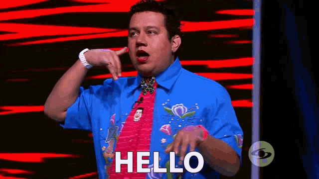 a man wearing a blue shirt and a pink tie is saying hello .