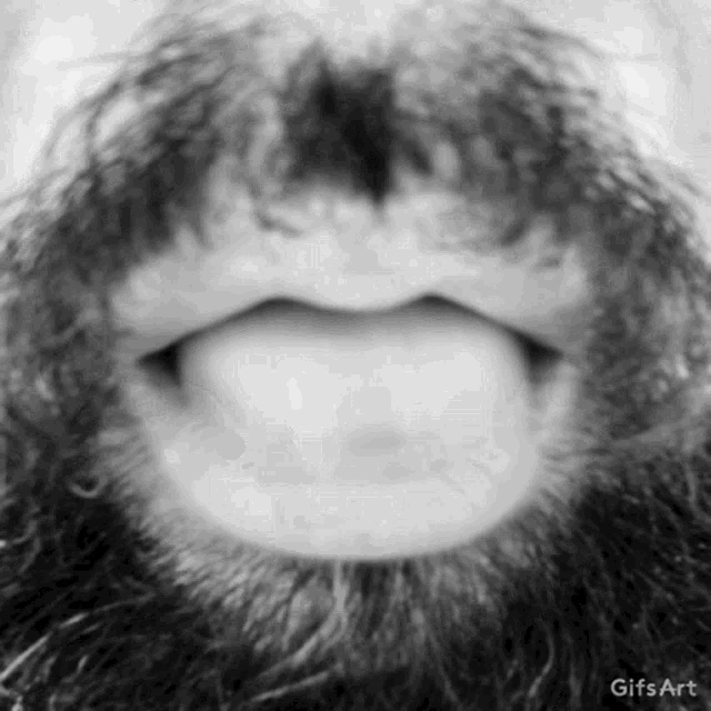a close up of a man 's mouth with a beard