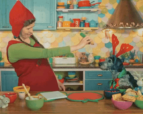 a woman in a red hat is cooking in a kitchen